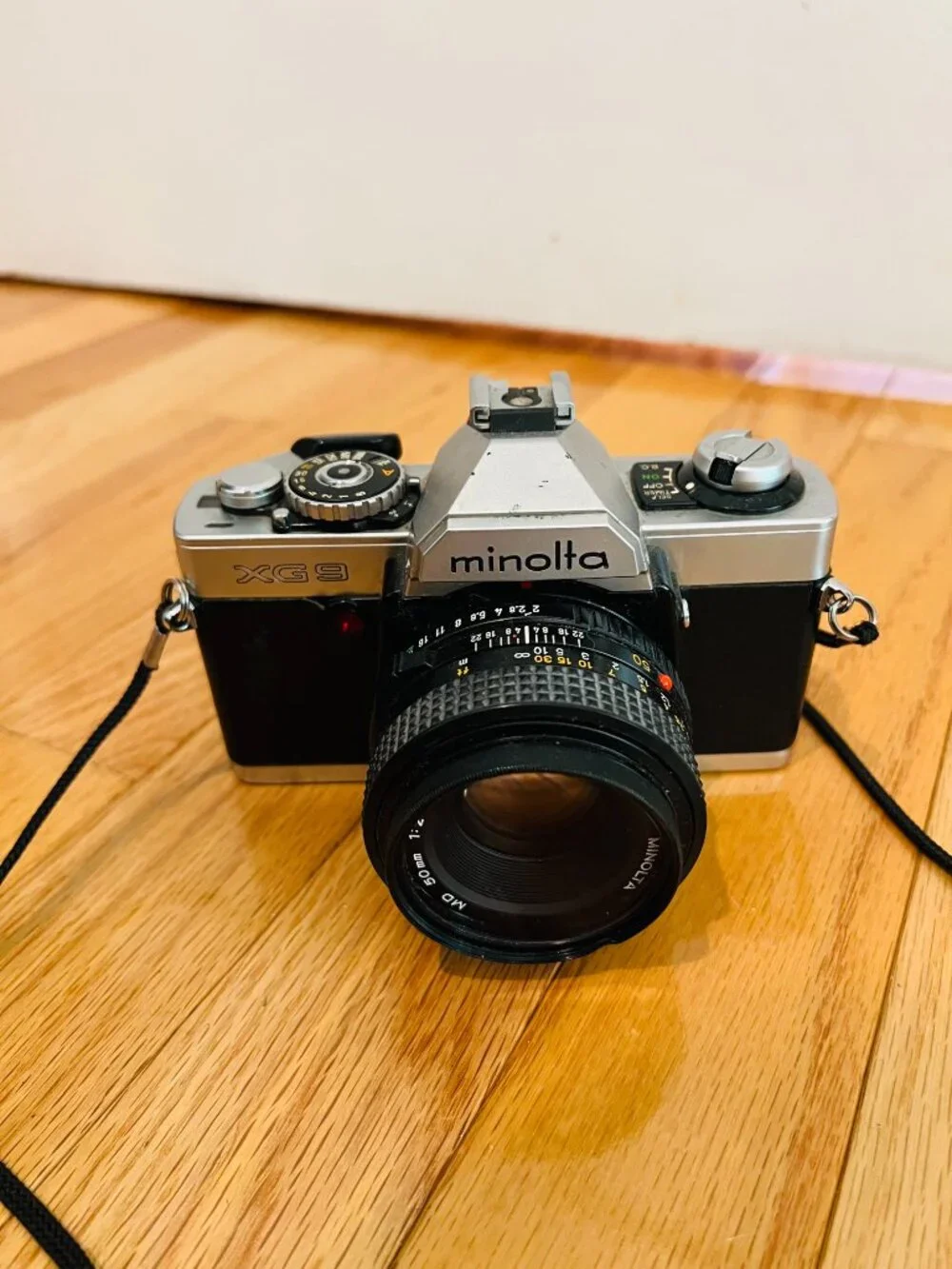 vintage Minolta XG-9 35mm SLR film camera equipped with a 50mm prime lens